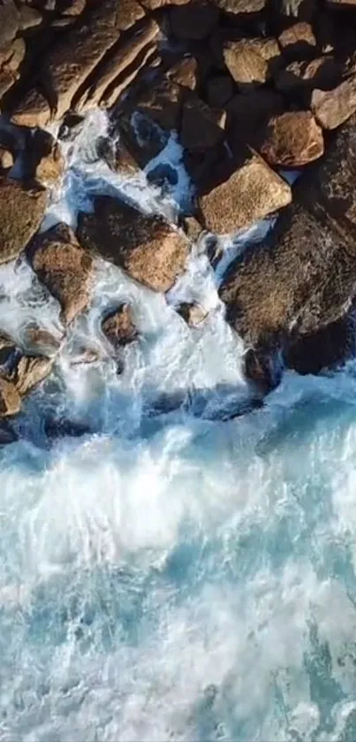 Aerial view of ocean waves crashing over rocky coastline.