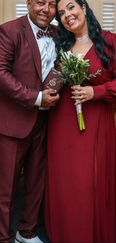 Elegant couple in burgundy attire celebrating their wedding.