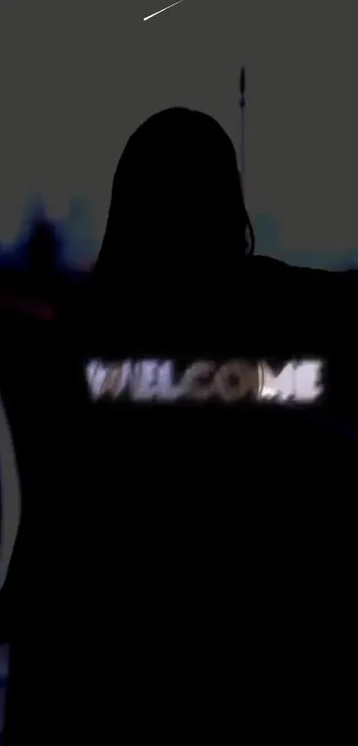 Silhouette with 'Welcome' glowing text on dark wallpaper.