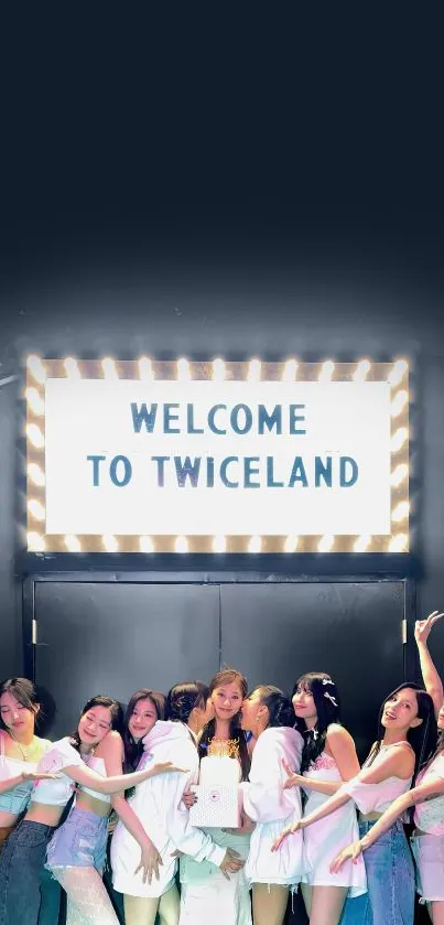 Mobile wallpaper with 'Welcome to Twiceland' sign and group photo.