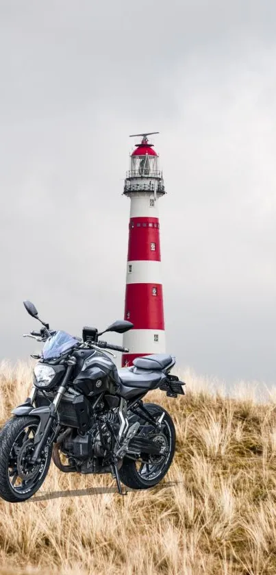 Sleek motorbike with red and white lighthouse in the background.