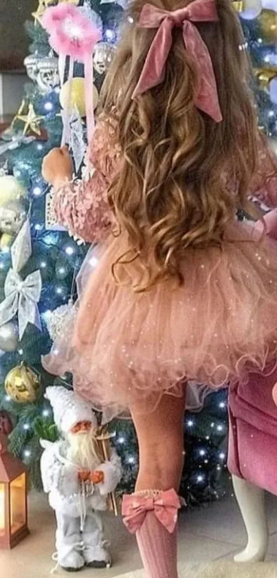 Girl in pink dress by Christmas tree with decorations.