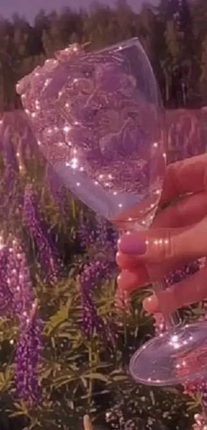 Hand holding glass in a purple lupine field.