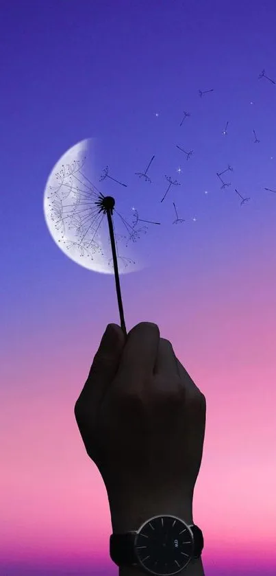 Hand holding dandelion against pink and purple sky with crescent moon.