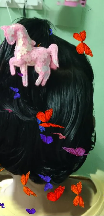 Whimsical pony clip with vibrant butterflies on dark hair.