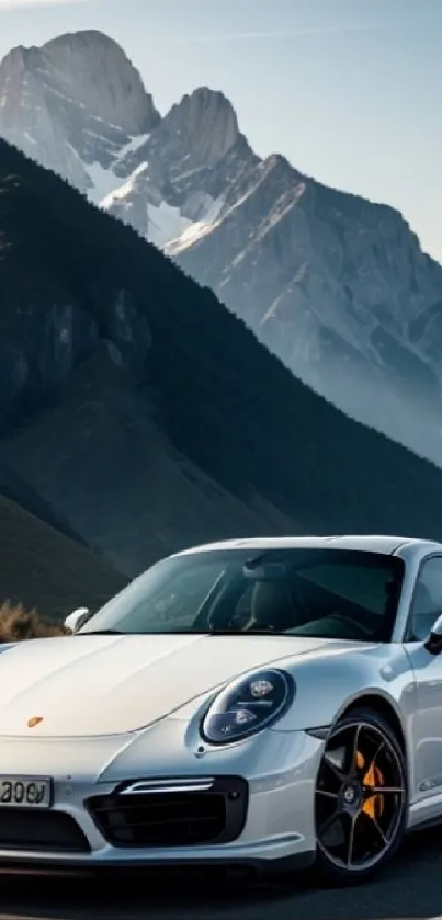 White sports car on a mountain road with scenic landscape view.