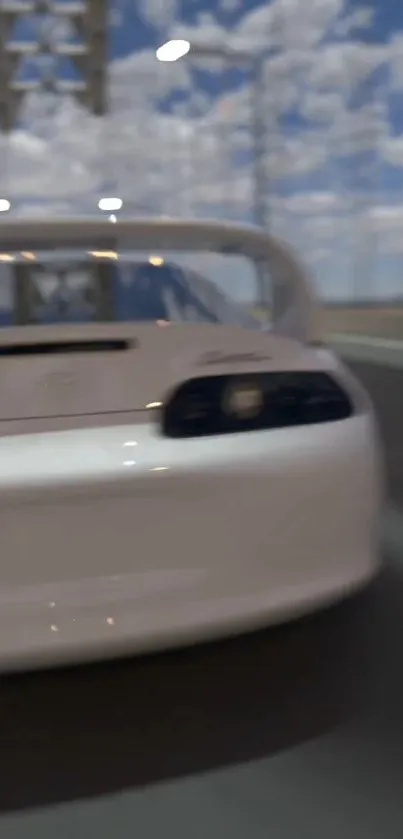 White sports car racing on highway, blurred background.