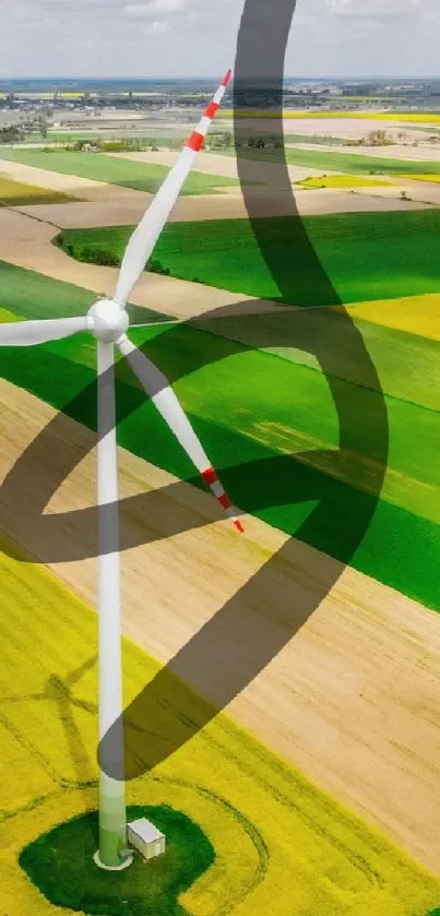 Wind turbine in lush green and yellow fields, aerial view.