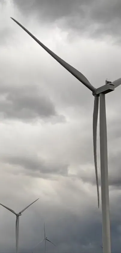 Wind turbines in a cloudy sky, showcasing eco-friendly energy.