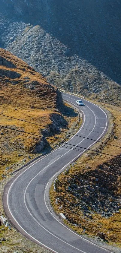 A winding mountain road through a golden landscape, perfect for mobile wallpaper.