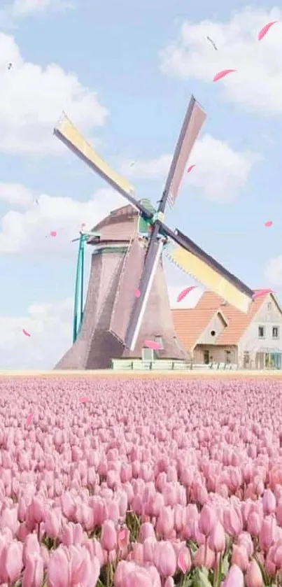 Windmill and pink tulips under a blue sky.