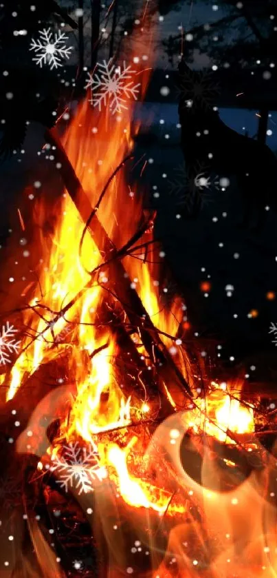 A blazing campfire with snowflakes in winter night backdrop.