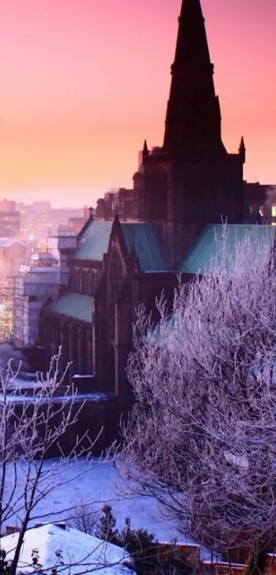 Gothic church silhouette at sunset with snowy landscape.