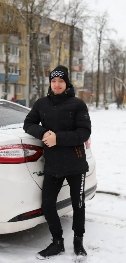 Person in jacket by a snow-covered parked car in an urban setting.