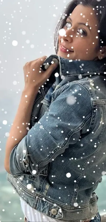 Person in denim jacket amidst falling snowflakes.