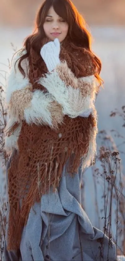 Woman in brown and blue winter attire standing in snowy landscape.