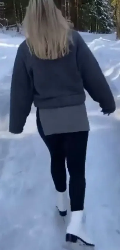 Woman walking on snowy path in forest.