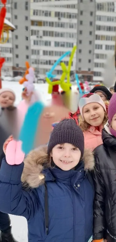 Kids enjoying snowy day with colorful balloons.