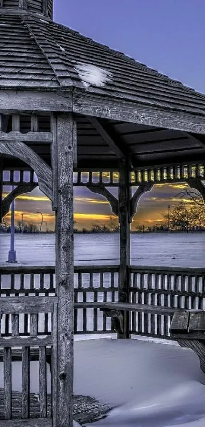 Snow-covered gazebo with purple sunset sky.