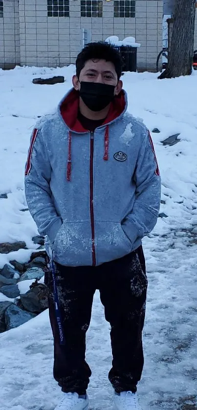 Person standing on snowy path in winter landscape.