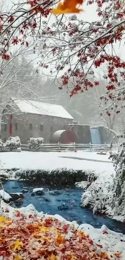 Snowy mill surrounded by autumn leaves and a flowing stream.