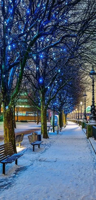 Winter cityscape with snow and blue lights on a riverside path at night.