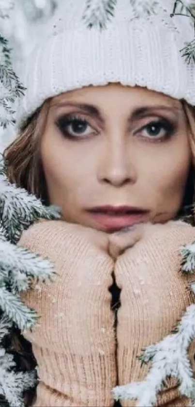 Winter portrait of a woman in snow with cozy mittens and hat.