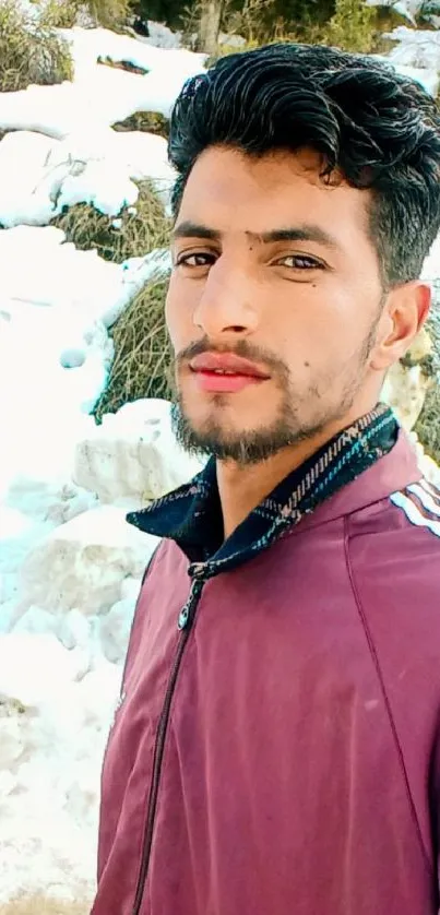 Portrait of a man standing in snowy winter landscape.