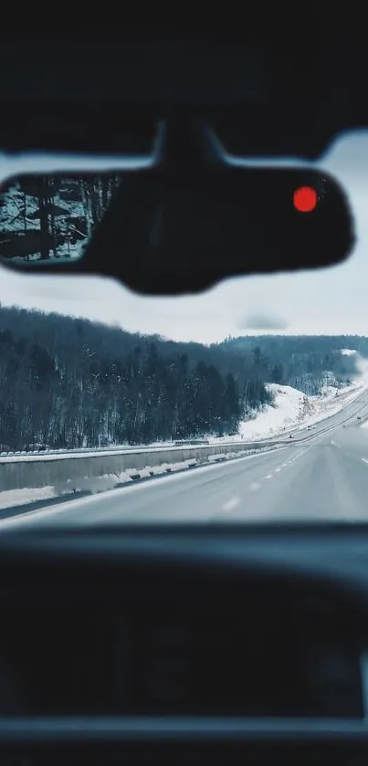 Winter view through car window on snowy highway.