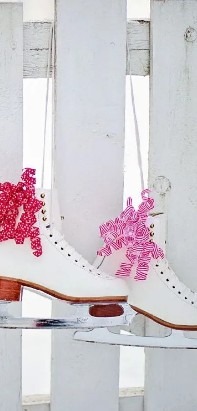 White picket fence with hanging skates and red ribbons.