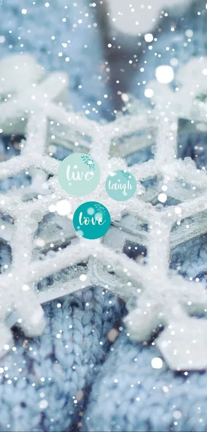 Winter snowflake on blue knit gloves with 'Live, Laugh, Love' text.