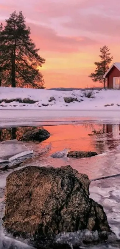 Winter sunset over frozen lake and snow-covered cabin.