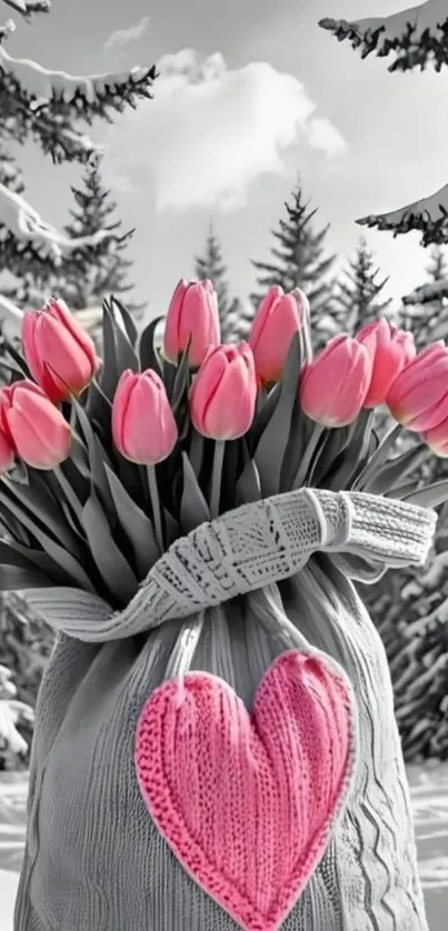 Bouquet of pink tulips in a gray knit bag with snow backdrop.