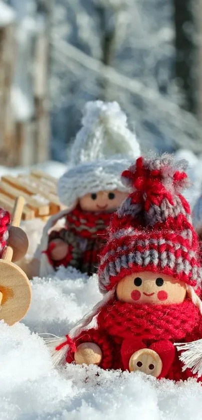 Handmade dolls in a snowy winter scene, wearing red knitted outfits.