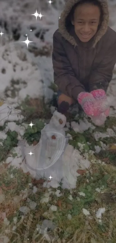 Child enjoying winter, building a small snowman with sparkles.