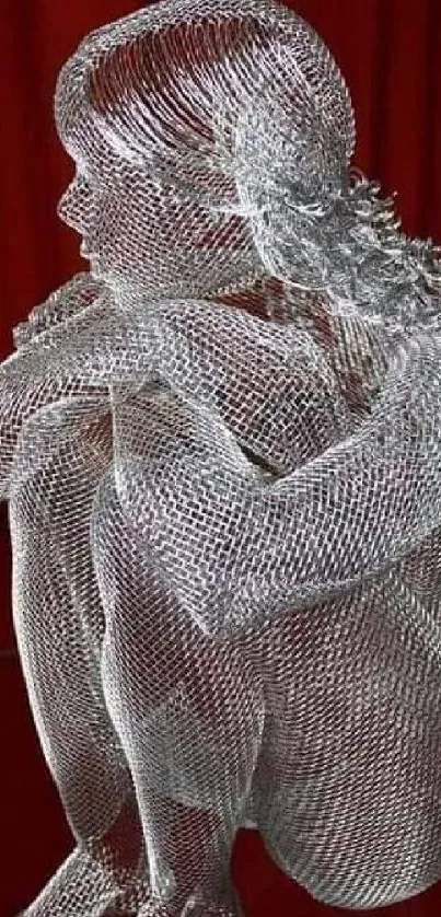 Detailed wire sculpture on a red background.