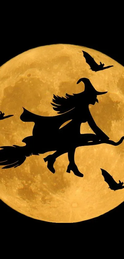 Silhouette of witch flying on broomstick with bats against full orange moon.