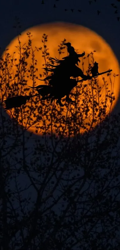 Witch silhouette flying across an orange full moon in a dark night sky.