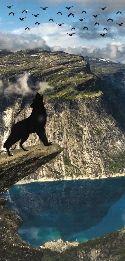 Wolf on mountain cliff with birds in sky and scenic lake view.