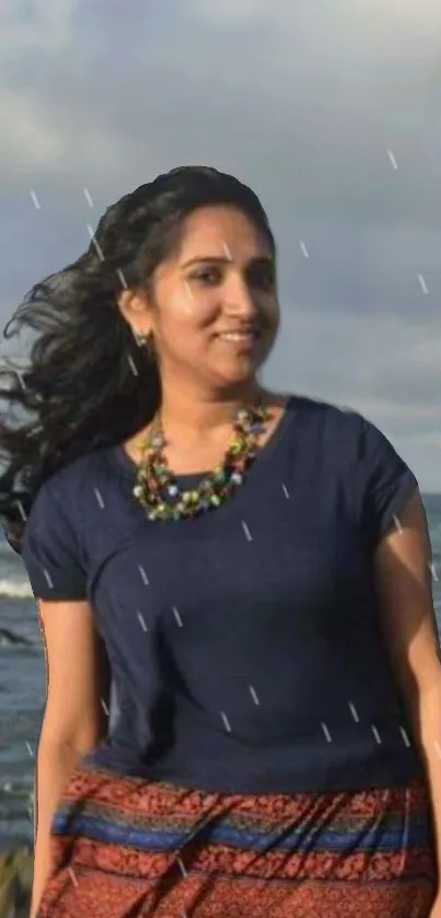 Smiling woman by the ocean, raindrops falling.