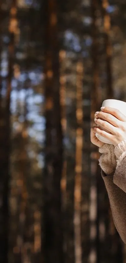 Woman enjoys a peaceful moment in a sunlit forest, sipping a hot drink.