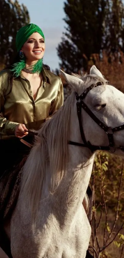 Woman riding a white horse through nature, wearing a green headscarf.