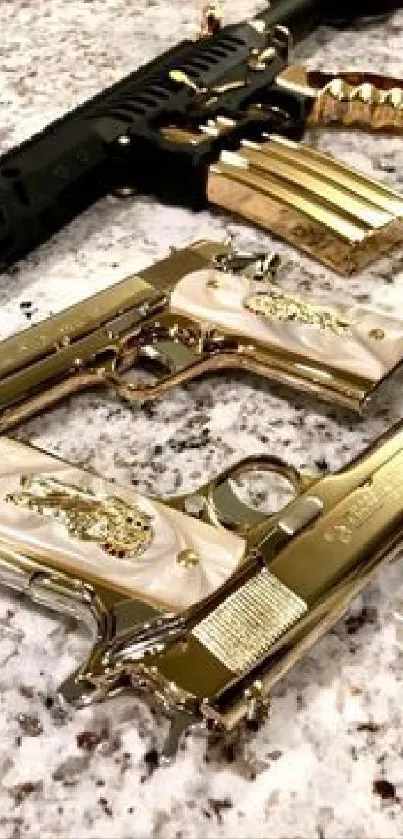 Gold and silver guns displayed on a marble surface.