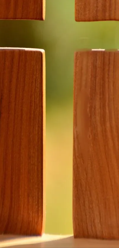 Wooden cross with sunlight creating a serene mobile wallpaper.