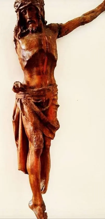 Wooden sculpture of Jesus on the cross, captured for mobile wallpaper.