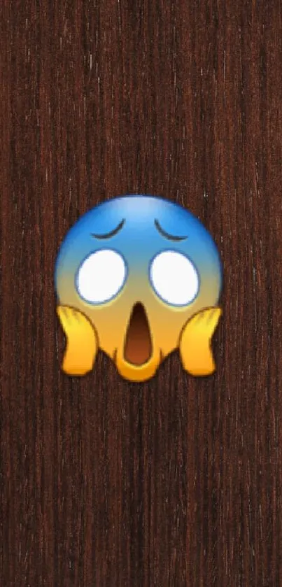 Shocked emoji on a dark wooden background for mobile wallpaper.