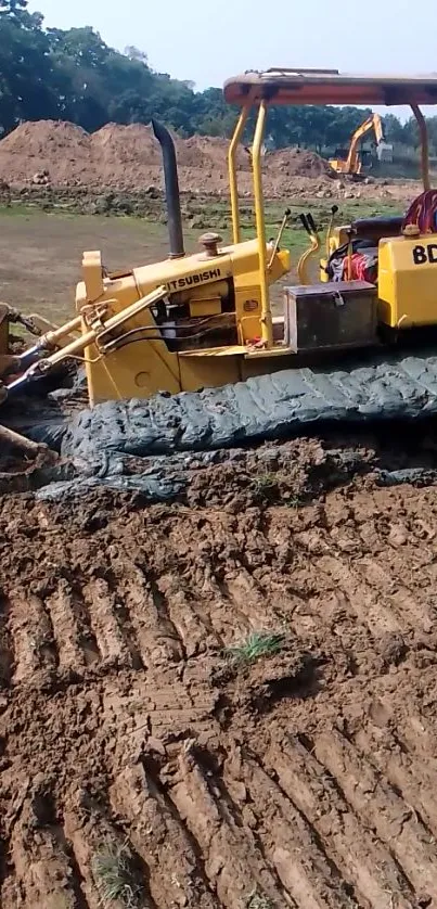 Yellow bulldozer on a dirt construction site.