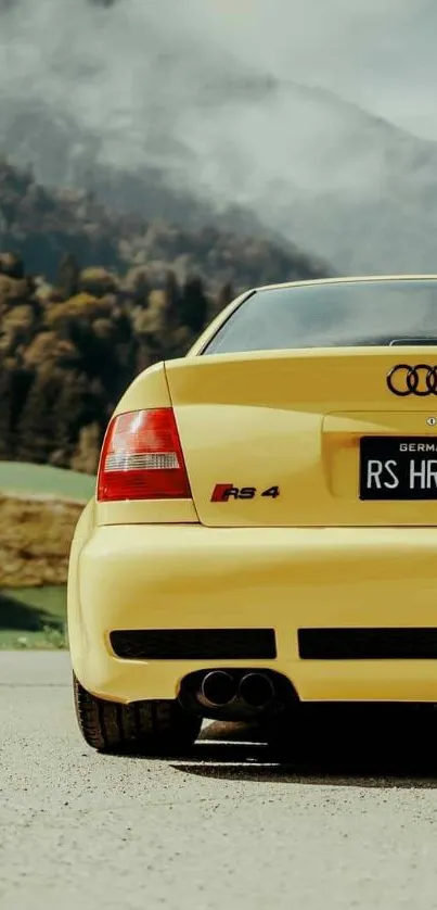 Yellow sports car parked on scenic mountain road.