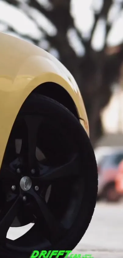 Close-up of a stylish yellow car wheel with a blurred background.