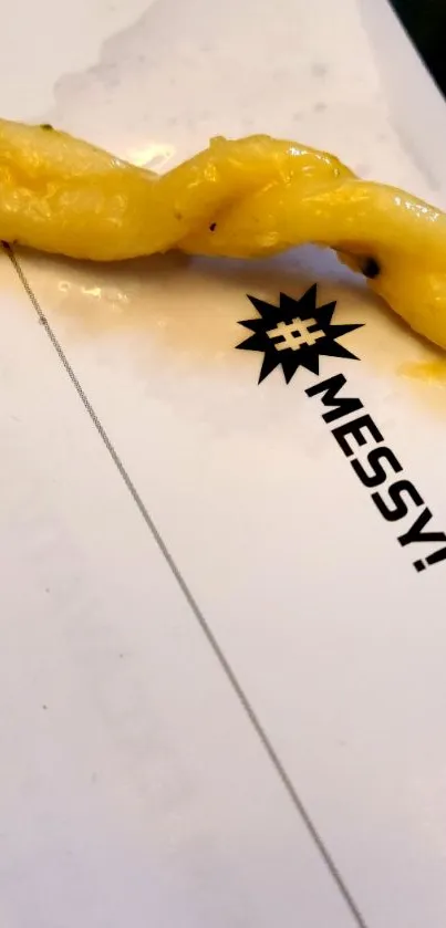 A solitary yellow fry on a messy table with the word 'MESSY!' emblazoned nearby.